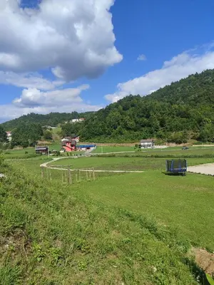 a field with a fence in the middle of a field at Vikednica ZEA