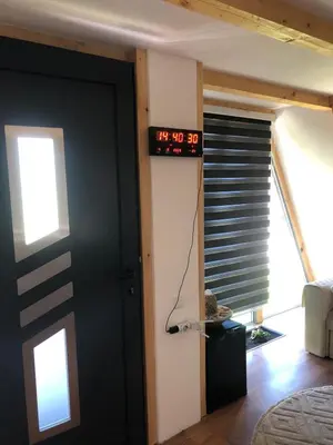 a room with a clock on the wall next to a door at Vikednica ZEA