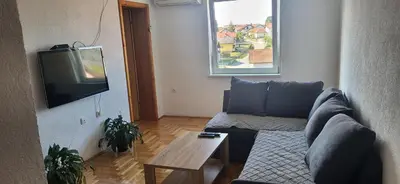 a living room with a couch and a tv at Apartman Kovacevic Prnjavor Republika Srpska in Prnjavor