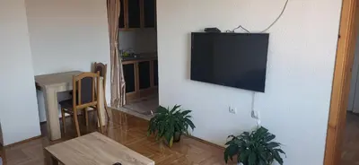 a living room with a flat screen tv on a wall at Apartman Kovacevic Prnjavor Republika Srpska in Prnjavor
