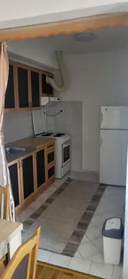 a kitchen with a white refrigerator and a stove at Apartman Kovacevic Prnjavor Republika Srpska in Prnjavor