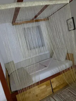 a bed with a net on top of it at Country House Bijela Voda in Bihać