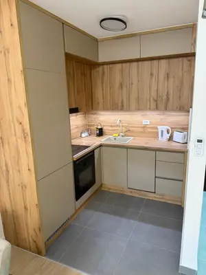 a small kitchen with a sink and a stove at Apartman Premium in Doboj
