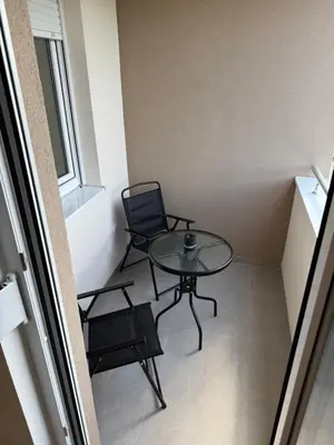 a small room with a table and a chair at Apartman Premium in Doboj