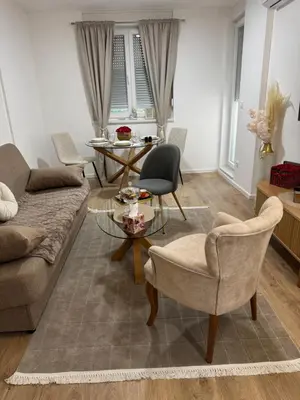 a living room with a couch and chairs and a table at Apartman Sofija in Doboj