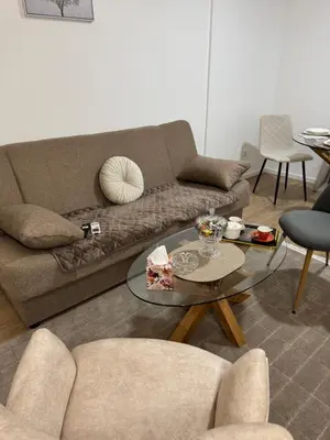 a living room with a couch and a glass table at Apartman Sofija in Doboj