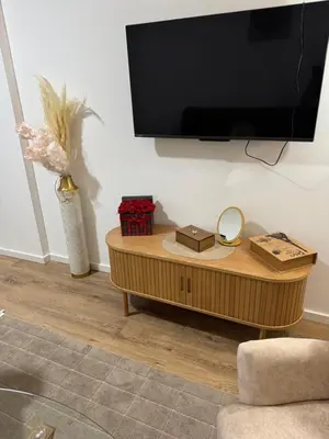 a living room with a tv and a coffee table at Apartman Sofija in Doboj