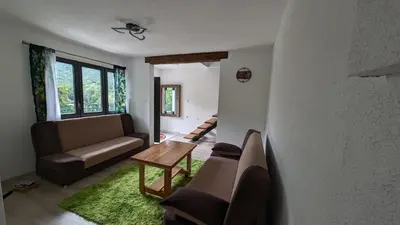 a living room with a couch and a table at River`s Song Cottage Jajce in Jajce