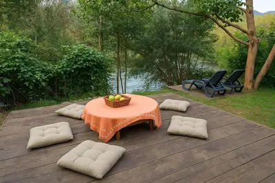 a table with a basket of fruit on a wooden deck at River`s Song Cottage Jajce in Jajce