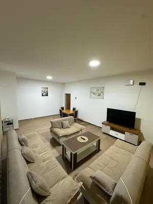 a living room with two couches and a flat screen tv at Apartmani Samardzic in Bosanska Gradiška