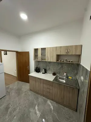 a kitchen with a sink and a counter top at Apartmani Samardzic in Bosanska Gradiška