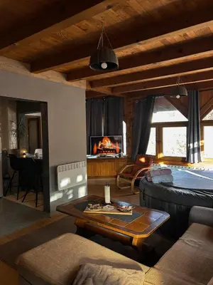 a living room with a couch and a table at Krivaja River Retreat - Jacuzzi, Pool and Basketball