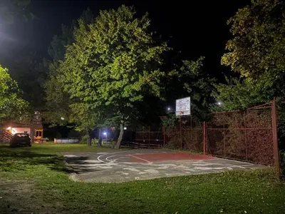 a basketball court in a park at night at Krivaja River Retreat - Jacuzzi, Pool and Basketball