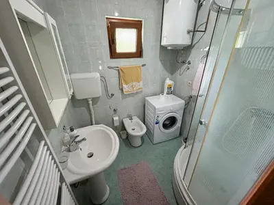a bathroom with a sink and a toilet and a shower at Krivaja River Retreat - Jacuzzi, Pool and Basketball