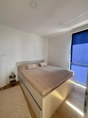 a bed in a room with a large window at Villa Stone House