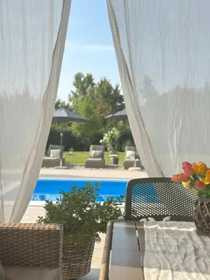 a view of a patio with a table and a pool at Villa Stone House