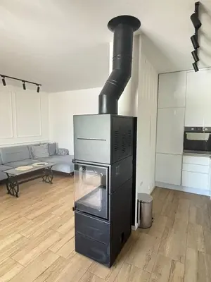 a stove in a kitchen with a living room at Villa Stone House