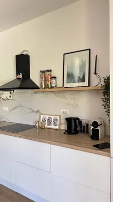 a kitchen with white cabinets and a counter top at Villa Stone House