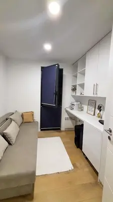 a living room with a couch and a black refrigerator at Villa Stone House