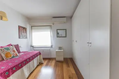 a bedroom with a bed with pink sheets and a window at Kuća za odmor u Bosanskoj Krupi in Bosanska Krupa