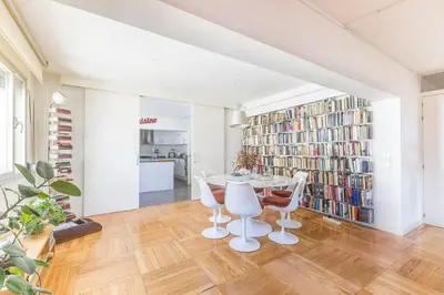 a dining room with a table and chairs and bookshelves at Kuća za odmor u Bosanskoj Krupi in Bosanska Krupa