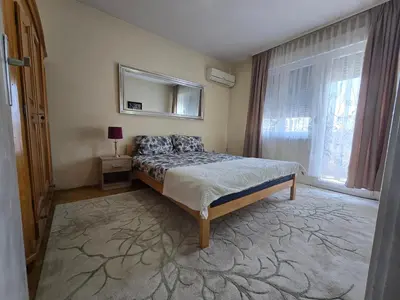 a bedroom with a bed with a mirror and a window at Abrazo in Orašje