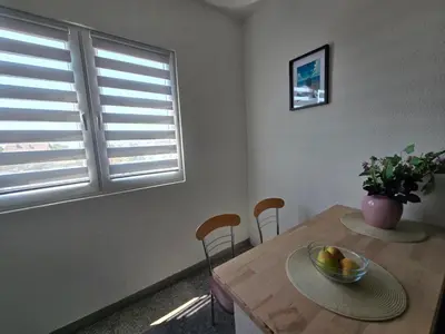 a dining room table with a bowl of fruit on it at Abrazo in Orašje
