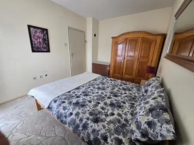 a bedroom with a bed and a wooden cabinet at Abrazo in Orašje