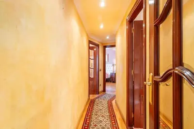 an empty hallway with doors and a rug at Moderan smještaj s parkingom Nova Bila in Nova Bila