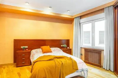 a bedroom with a bed with yellow walls and a window at Moderan smještaj s parkingom Nova Bila in Nova Bila