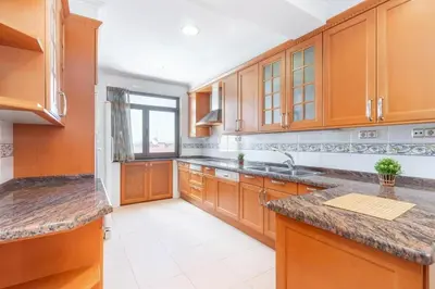 a large kitchen with wooden cabinets and a sink at Moderan smještaj s parkingom Nova Bila in Nova Bila