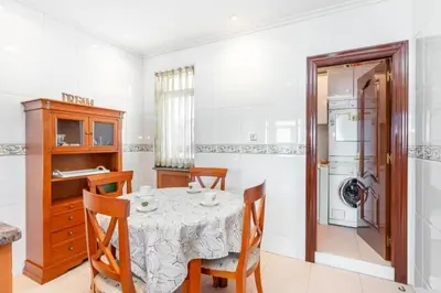 a dining room with a table and a refrigerator at Moderan smještaj s parkingom Nova Bila in Nova Bila