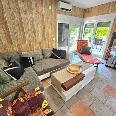 a living room with a couch and a table at Vikendica na Sani Datea in Sanski most