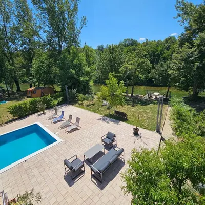 an overhead view of a swimming pool with chaise lounge chairs and a swimming pool at Vikendica na Sani Datea in Sanski most