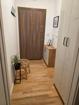 a hallway with a door and a wooden floor at Terra Lux in Travnik