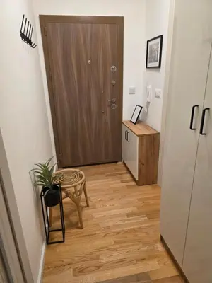 a hallway with a door and a table and a chair at Terra Lux in Travnik