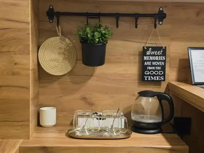 a shelf with glasses and a pot on a wall at Terra Lux in Travnik