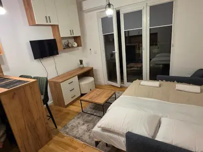 a bedroom with a bed and a desk and a television at Terra Lux in Travnik