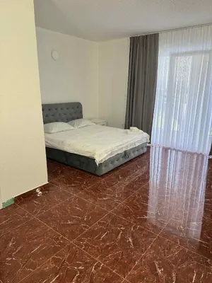 a bedroom with a bed and a tiled floor at Dvorac Kastel in Ljubače