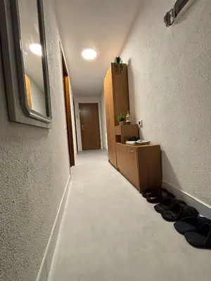 a hallway with a room with shoes on the floor at Apartman Rejjan in Zenica