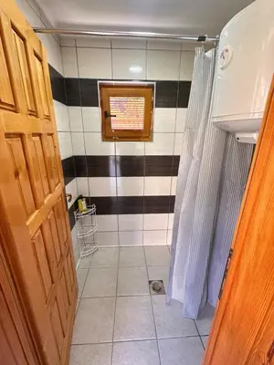 a bathroom with a black and white striped wall at Oaza Vrbas - Riverside Bungalow near Jajce in Vinac
