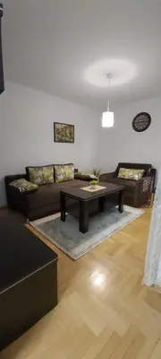 a living room with a couch and a coffee table at AnyBL02 in Hiseti