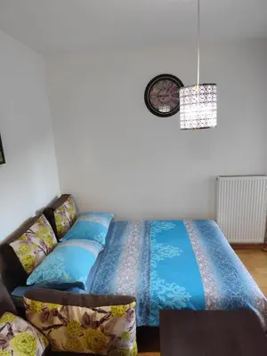 a couch with blue pillows in a living room at AnyBL02 in Hiseti