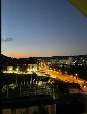 a city lit up at night with street lights at Apartment Meskovic in Tuzla