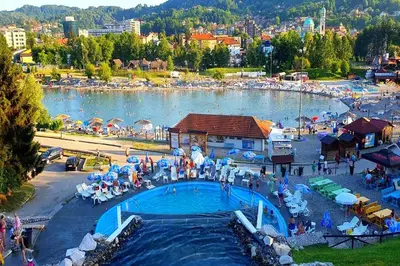a group of people standing around a pool at a water park at Apartment Meskovic in Tuzla
