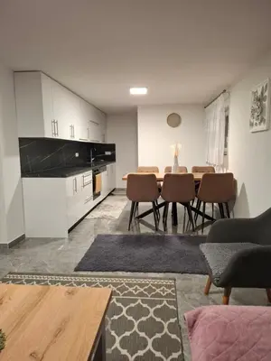 a living room with a table and chairs at Apartman Ventus in Bihać