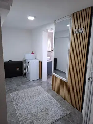 a room with a bathroom with a refrigerator and a mirror at Apartman Ventus in Bihać