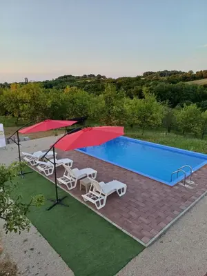 an overhead view of a swimming pool with two chairs and an umbrella at Vikendica Hangover in Gradačac
