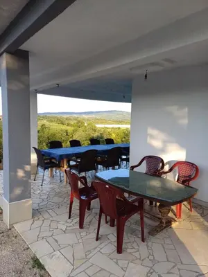 a group of tables and chairs on a patio at Vikendica Hangover in Gradačac