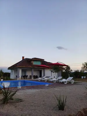 a house with a swimming pool next to a house at Vikendica Hangover in Gradačac